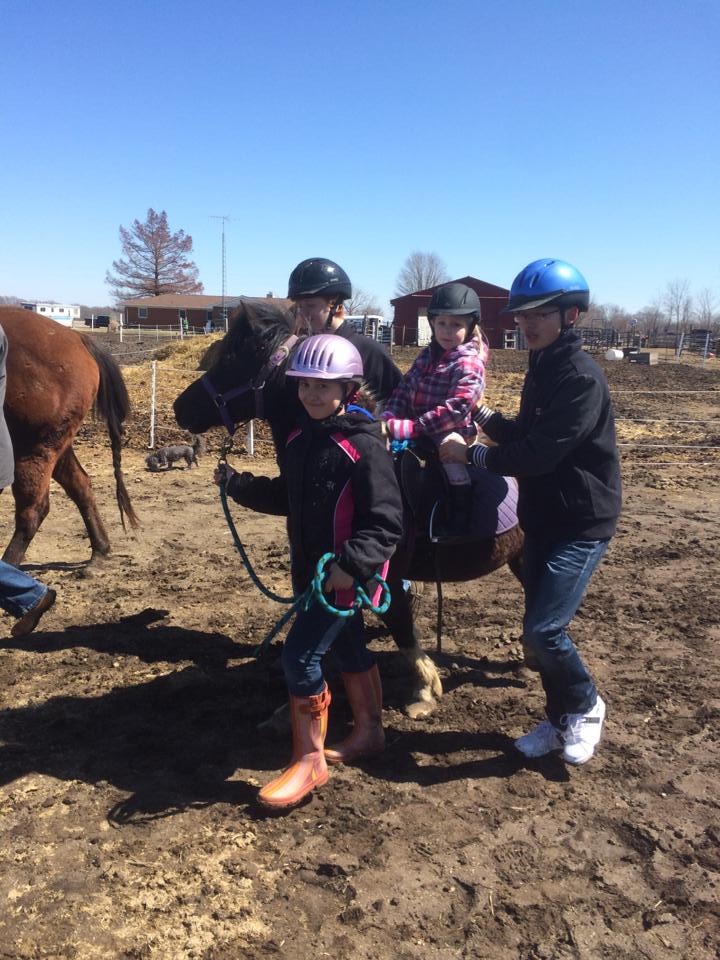 3 year old rides horse